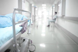 Hospital Hallway Emergency area showing a stretcher and a man sitting down in the lobby.
